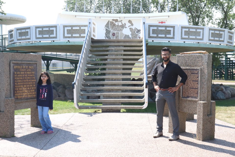 Khurram Abbasi and his daughter, Fatima, visit the UFO Landing Pad in the Town of St. Paul on Aug. 22, 2022.