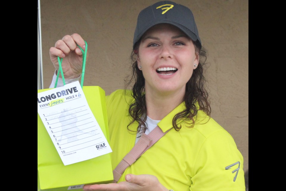 Stephanie Monteith was smiling brightly despite a cloudy day on the course with her prize package for the ladies long drive of the tournament. This was the first year that Lac La Biche has hosted a golf tournament to support the regional Road To Hope organization.