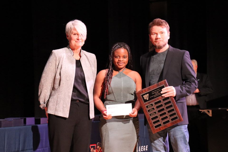 Miriam Kabonesa, a multi-sport Voyageur student-athlete was presented with the Volunteer of the Year Award for her work outside of sports. The award was presented by Portage College's Bev Moghrabi and Lac La Biche County Mayor Paul Reutov.