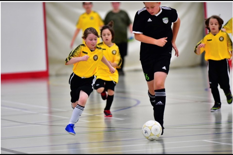 Bonnyville player Conner Woods in black goes up against Lac La Biche's U13 player Ben Dyment in recent league play during a Lac La Biche-hosted soccer weekend. Also in the photo are Lac La Biche players Jordan Lameman and Merrick Davies.