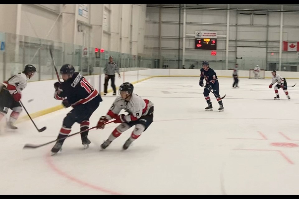 Voyageur defenceman Logan Carruthers works against two Korean University players in the Lac La Biche zone during first period action on Saturday night. 