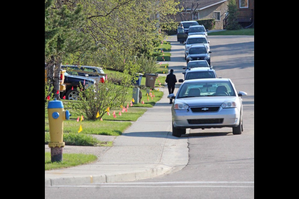 Utility flags line a Dumasfield street near Beaverhill Road as fibre-optic cable is prepared to be offered to area residents.