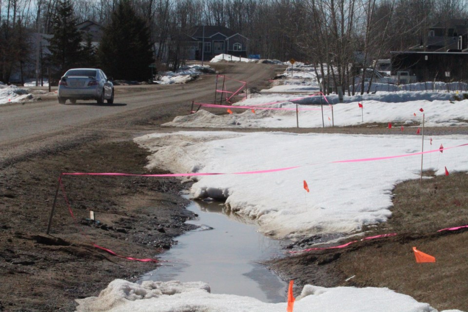 Caution tape highlights some areas where Telus contractors dug in fibre lines to residences in a Lac La Biche County subdivision.