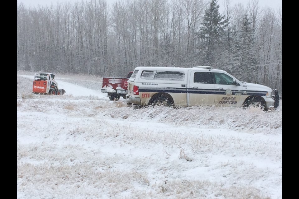 Lac La Biche community peace officers and construction equipment were working in a frosty field last Thursday, tearing down a tent city encampment.   Image Rob McKinley