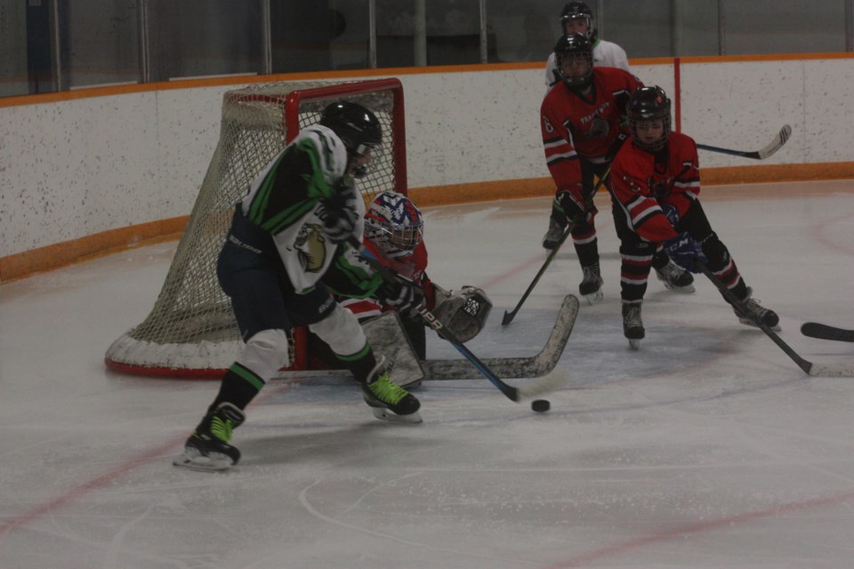 Plamondon Cougars' Owen Tibbetts glides into the crease on a wrap-around attempt on the TrailsWest Wolves goalie in action from Saturday's 2-2 tie.