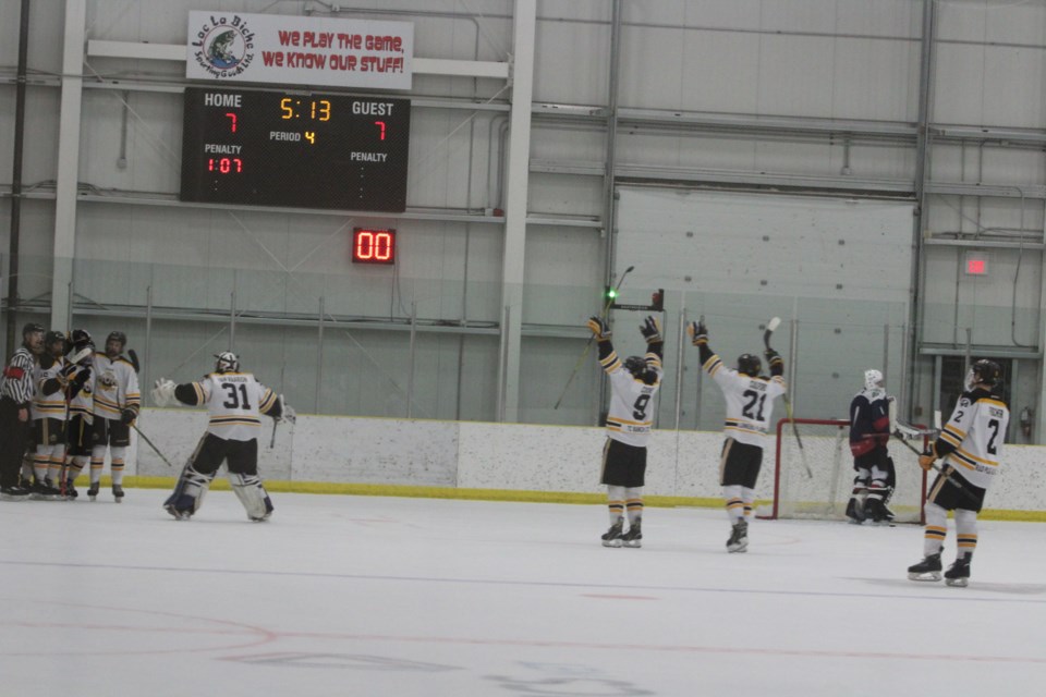 The Tigers celebrate their OT goal as Clippers goalie Joshua Irving heads to the bench.