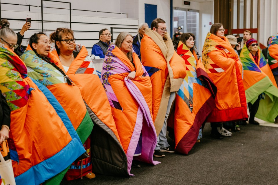 Residential school survivors, ground search team members, and other dignitaries receive star blankets on April 19 at UnBQ.