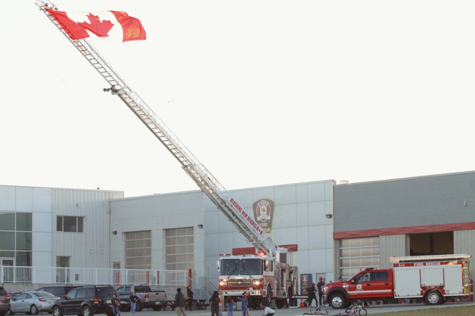 A giant Canadian flag flies from the top of the 100-foot aeirial ladder at the recent Fire Prevention Week open house at the Lac La Biche County Protective Services Building.