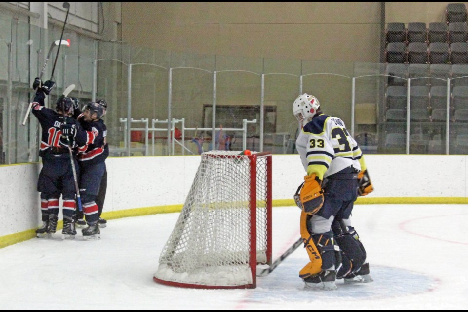 Voyageurs celebrate their first goal  — from Brody Dale — behind Ooks goalie Ryley Osland near the end of the first period of Friday's night's game at the Bold Center.