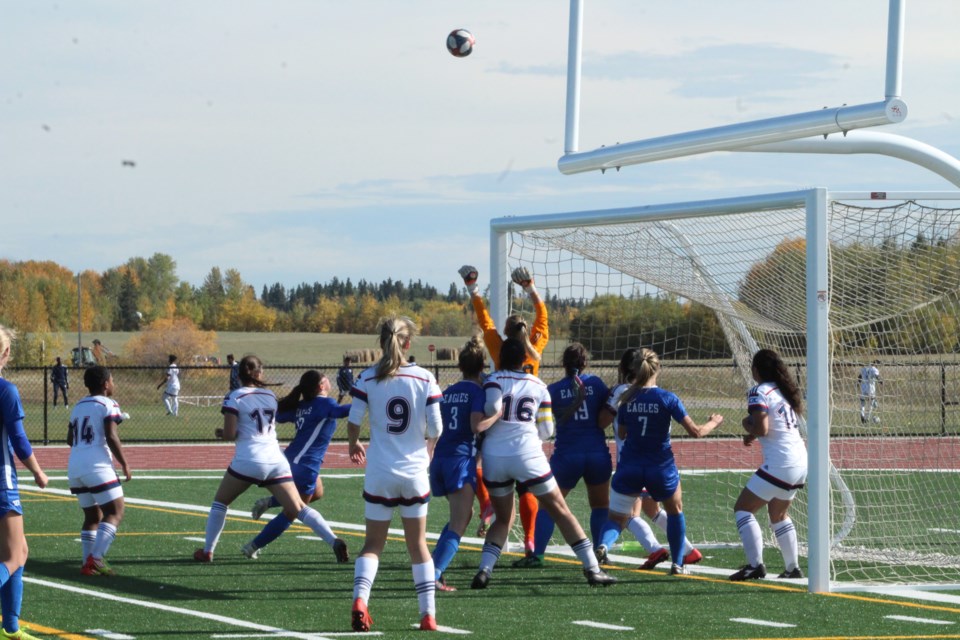 Voyageur goalie Sydney Kushnerik  goes up for the Eagle's high corner kick in Saturday action at the Bold Center field.