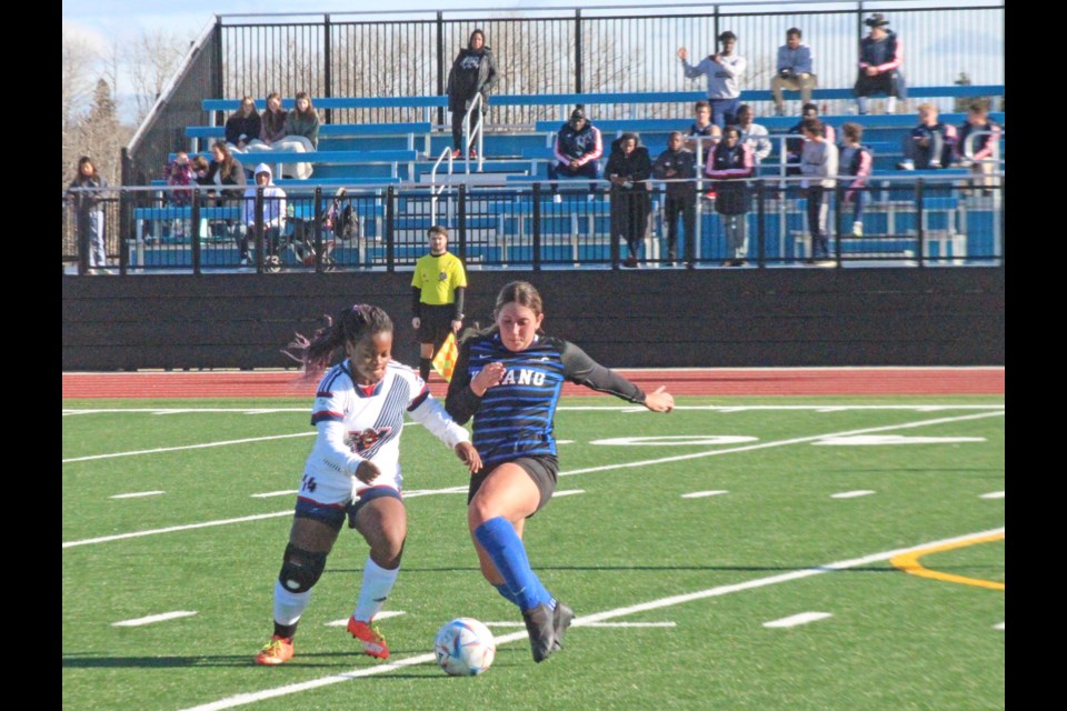 Voyageurs' midfielder Miriam Kabonesa chases for the ball against  a Keyano attacker.