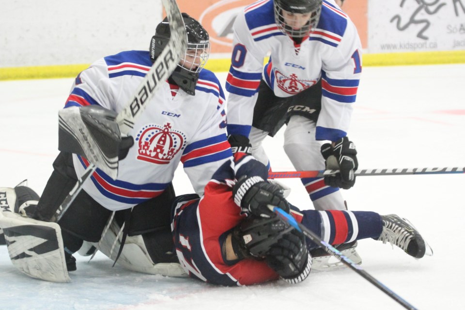 Monarchs goalie Trent Chartrand and defenceman Braxton Martin keep Clippers forward Warren Durette on the ice. Martin was issues a five minute match penalty for intent to injure on the play during Sunday afternoon's 10-7 Clippers' win.