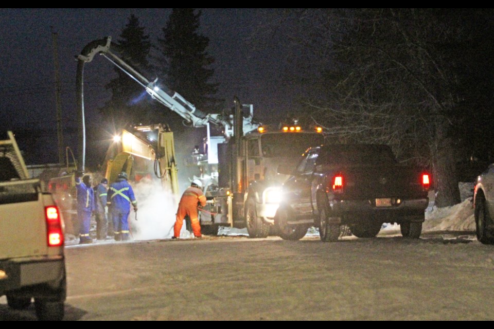 Crews work into the night last week on a water pipe break in a residential area near the Lac La Biche Legion. The break is drawing attention to the replacement plan for much of the community's aging utility infrastructure.