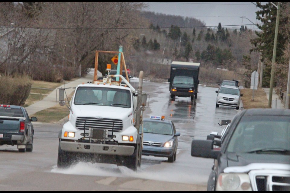 A Lac La Biche County municipal water truck sprays down a street in the hamlet on Thursday afternoon. Access to water for residents in more remote areas of the municipality for drinking and fire protection is a growing concern.