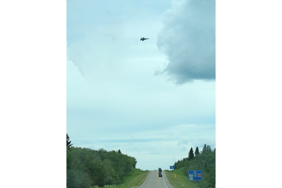 A CF-188 Hornet flies over Highway 28 at the western entrance to Cold Lake. This week the base has been hosting a NORAD-based training event.