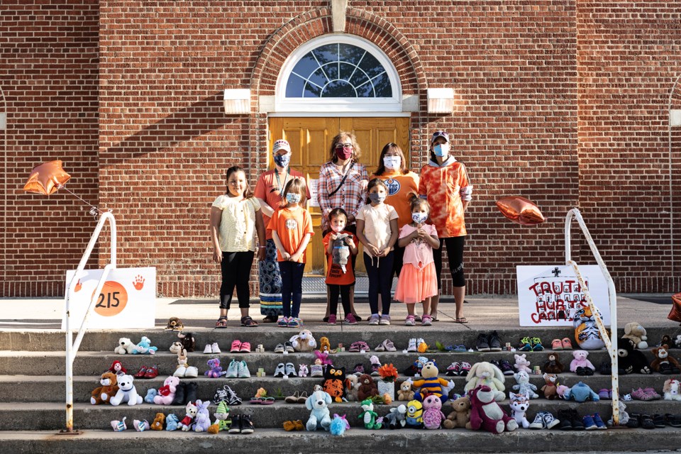 Head Start staff members Sarah Weimer, Muriel Benson,  Jessica Jackson, and  Twila Anderson organized a memorial on the steps of the St. Paul Cathedral, Monday night. Also pictured is: Trinity Anderson,  Serenity Mahe, Oakleigh Mahe, Lanaya Anderson and Maycee Papin Anderson. / Janice Huser photo