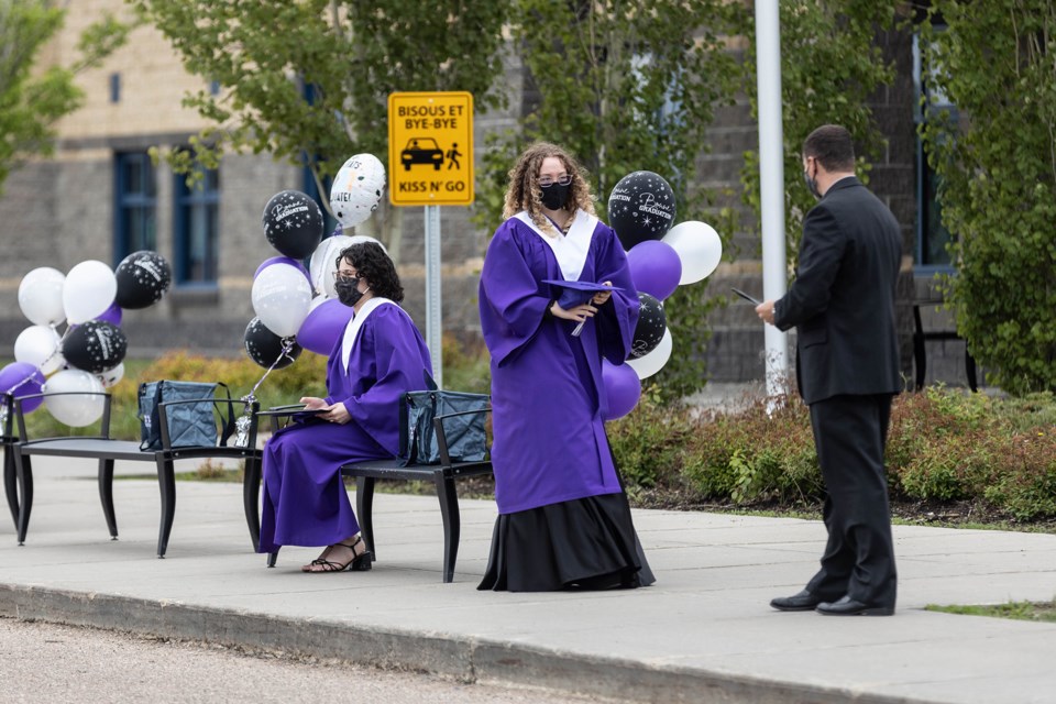 Graduates from École du Sommet take part in an outdoor graduation ceremony, on June 5.