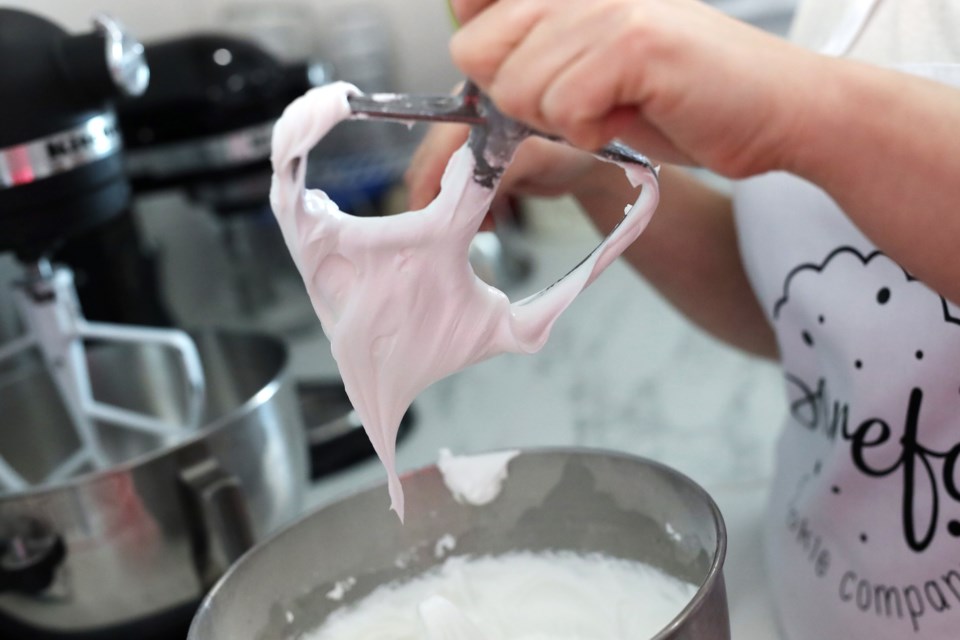 Melissa Landiak creates the icing for her custom cookies.