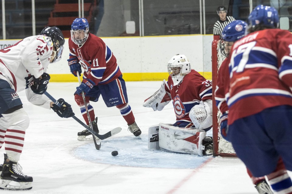 No stick, no problem. The Canadiens goalie keeps his eye on the puck despite his stick being out of reach behind the net. 