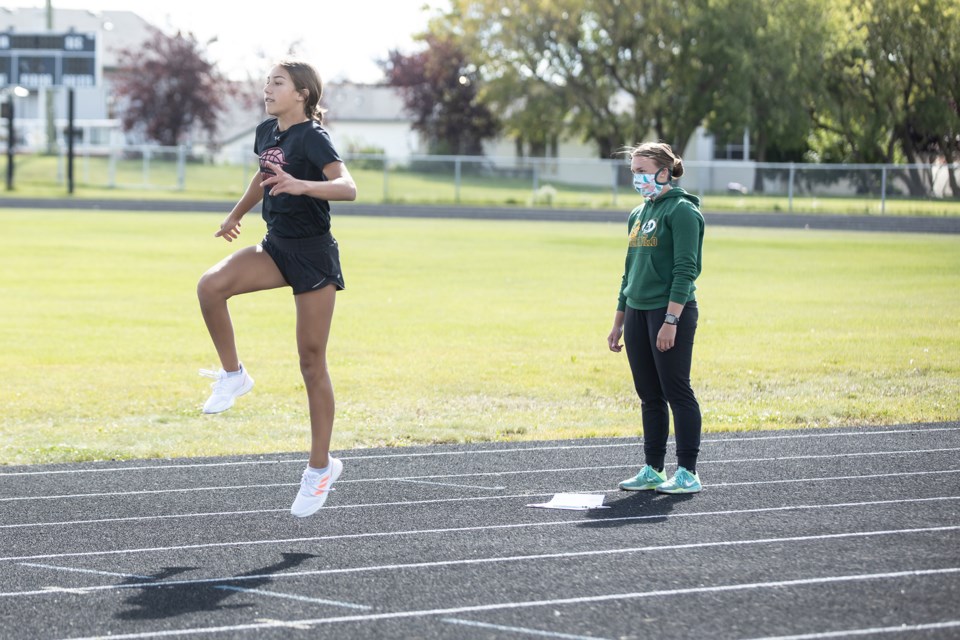 Kayley Gerlinksy completes a drill while Courtney Hebert watches. Janice Huser photo.