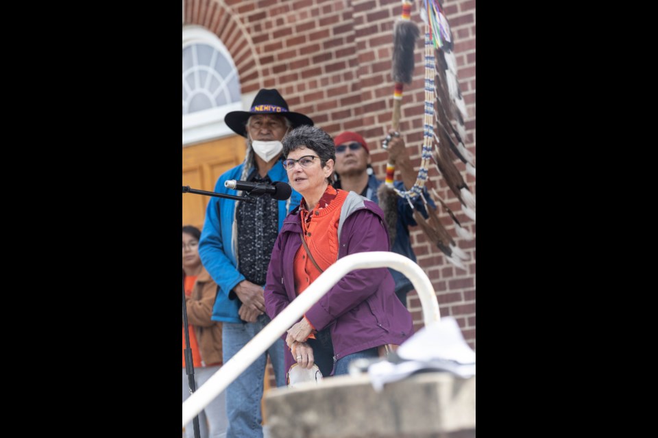 Town of St. Paul Maureen Miller speaks to a crowd in front of the cathedral, June 8.
