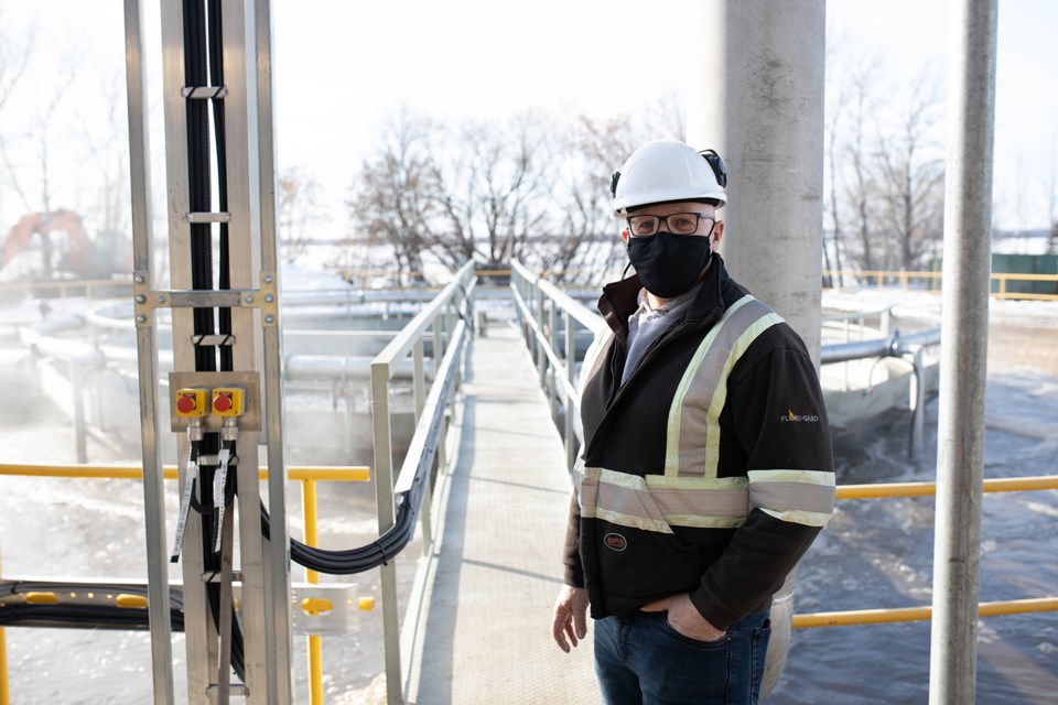 Bert Pruneau stands in front of one of the activated sludge reactors.