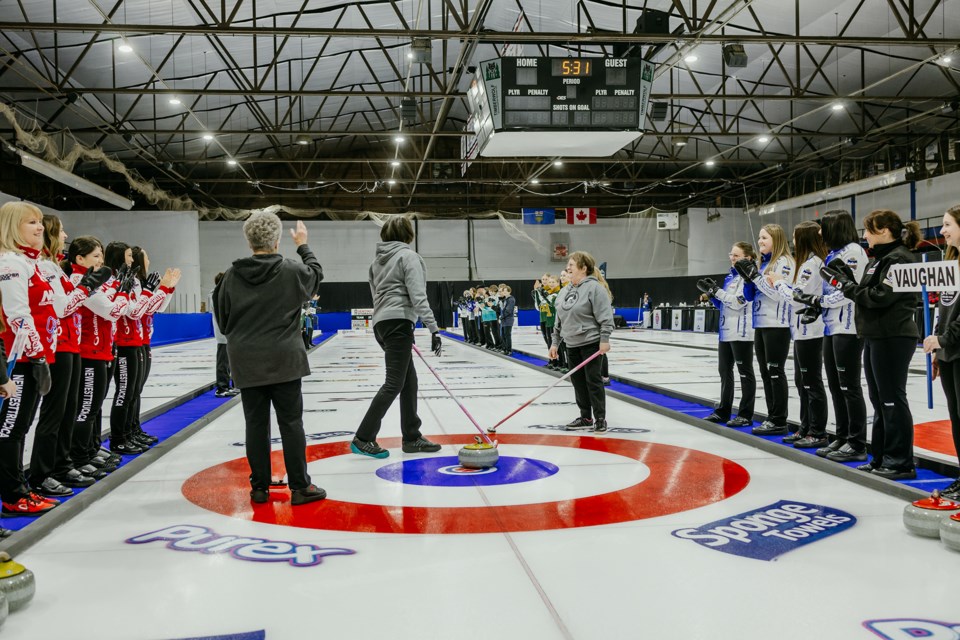 The ceremonial first rock is thrown on Wednesday night by long-time St. Paul Curling Club members.