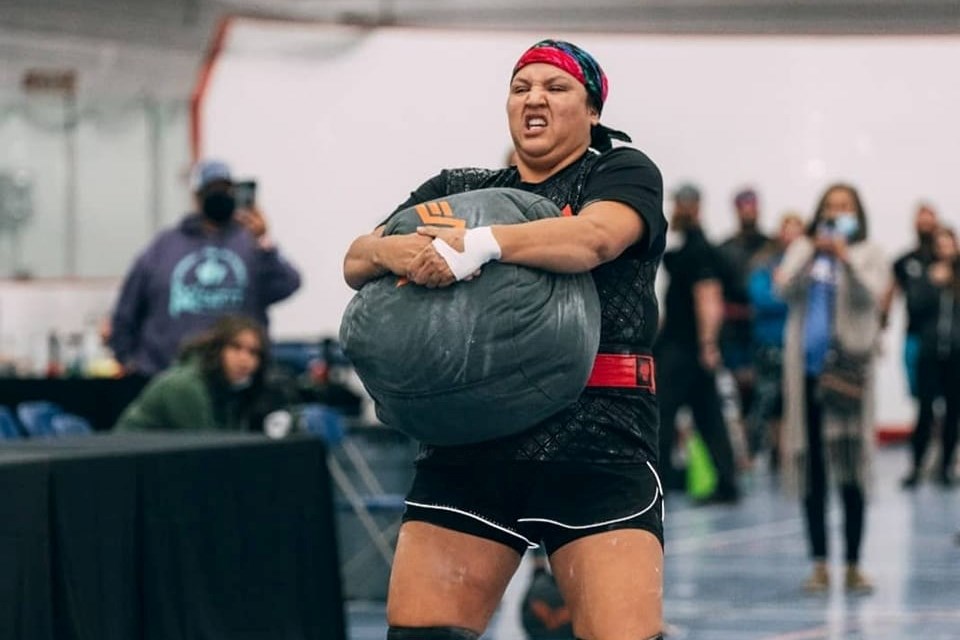 Angela Houle carries a sandbag during the amateur national strongman competition in Fort McMurray in October.