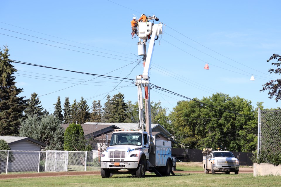 ATCO crews work to restore power on July 21, in St. Paul. / Mario Cabradilla photo