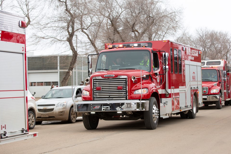 A long line of emergency service vehicles drive past the St. Paul hospital and the Health Unit on Thursday afternoon, as a way to say thank-you to healthcare workers.