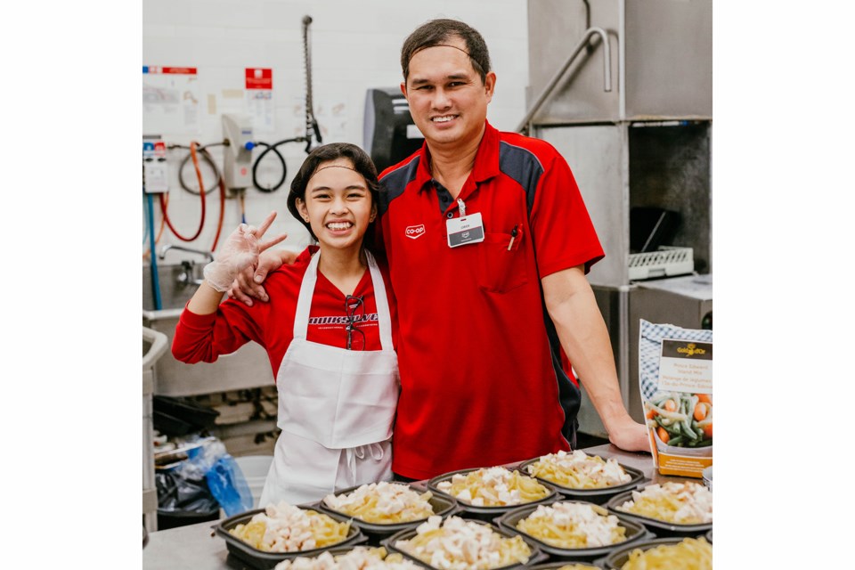 Janeia Pamintuan and her dad, Jorich, are pictured working at the Cornerstone Co-op Deli on Nov. 2 during Take Our Kids to Work Day.
