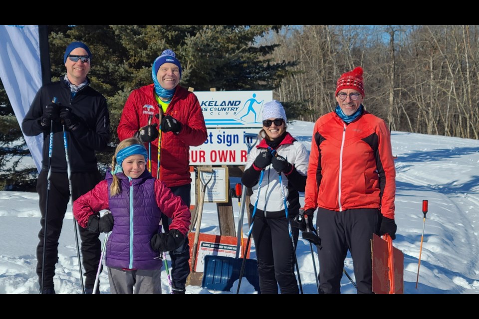 Skiers and organizers welcome people to Westcove for a day of cross-country skiing. 