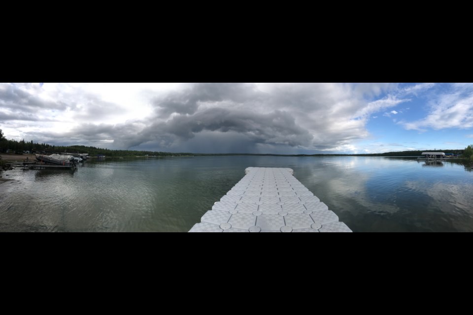 The sky is split by a late July rain storm over Beaver Lake in Lac La Biche County. The region has experienced cool temperatures and rain this week after weeks of summer heat.