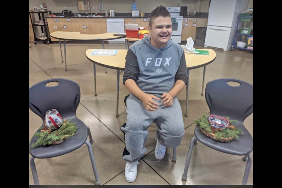 Aiden Boostrom is all smiles as he presents two of the centrepieces he helped to create in the JAWS Life Skills class.