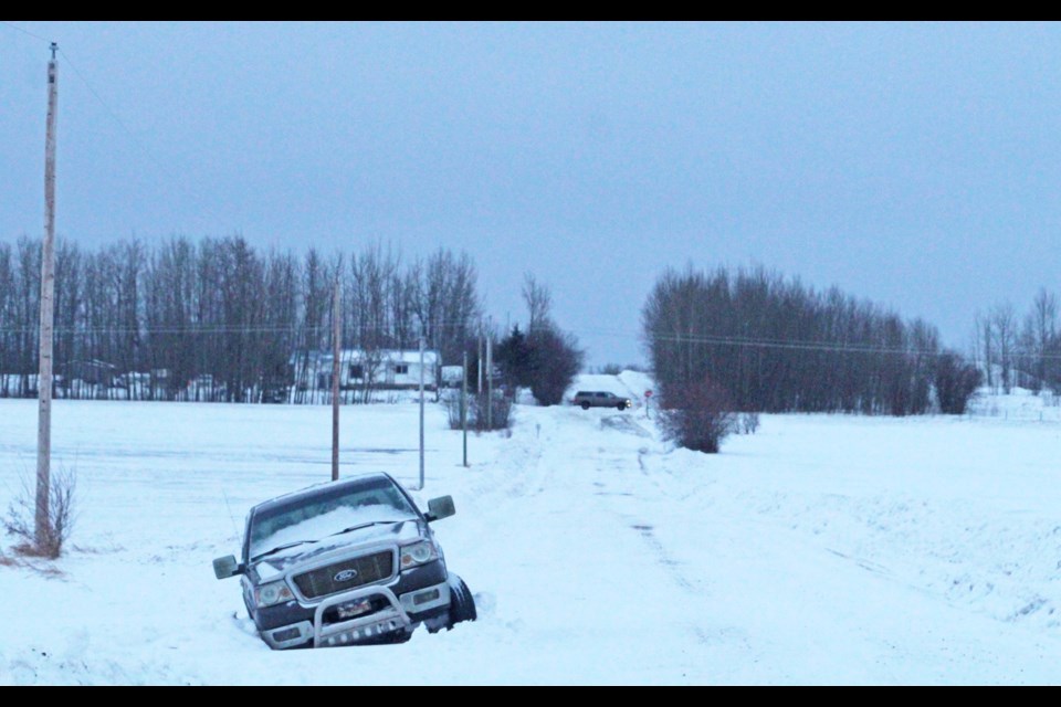A truck sits abandoned after it slid into the ditch of a rural road west of Plamondon during the recent wind storm.  Municipal peace officers say they responded to several calls about vehicle crashes during the overnight windstorm.    Image Rob McKinley.