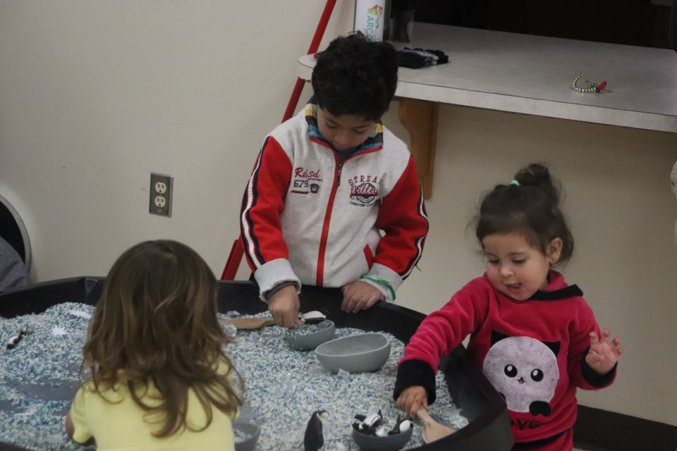Children playing a winter sensory play activity.