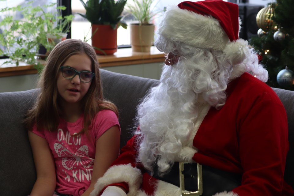 Sophie Burton takes a picture with Santa.