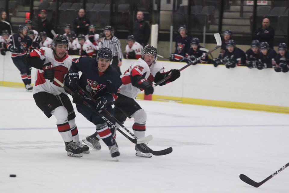 Voyageurs forward Graeme Patrick is flanked by SAIT Trojans players Tanner Sidaway and Keigan Casey during last Saturday's loss at the Bold Centre. The Voyageurs are hoping to snap their winless streak this weekend against NAIT. Chris McGarry photo. 

