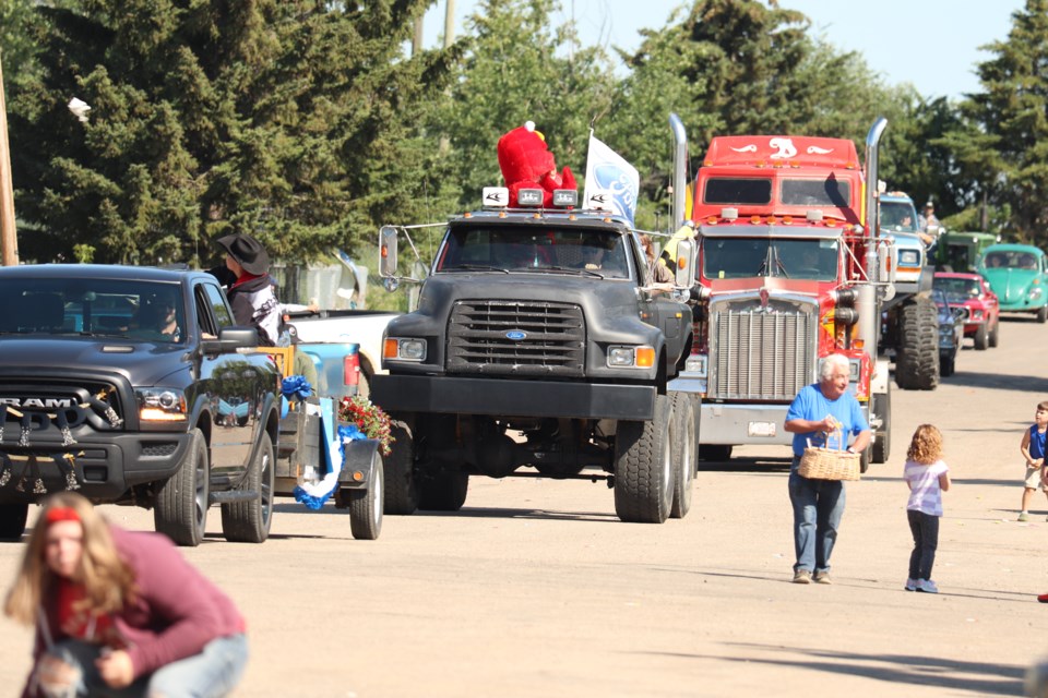 The Ashmont Heritage Days parade entries shower the main street spectators with candies as spectators grab all the sweets they can get on Aug. 6. The parade was just one of many events that took place during Ashmont Heritage Days. 