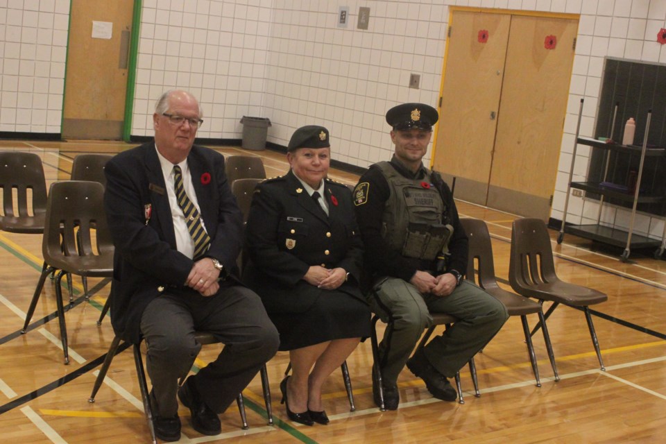Danny Stevens, president of the McGrane Branch of the Royal Canadian Legion in Lac La Biche, Capt. Debbi-Jean Cyre of the Canadian Forces, and Alberta Fish and Wildlife officer Brad Semeniuk, were amongst the dignitaries who attended the Remembrance Day ceremony which took place at Light of Christ Catholic School on Wednesday. Chris McGarry photo.