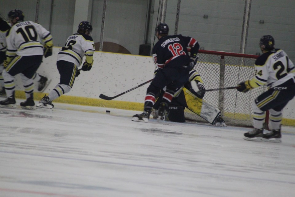 Shaye Sommerfeld takes advantage of an opening in the OOKs and net and makes an attempt to get the puck past goaltender McCoy Bidewell. Chris McGarry photo. 