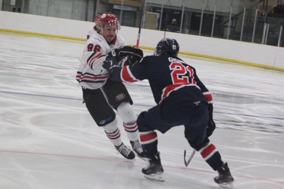 Portage College Voyageurs defenceman Nick Gidney was doing his job during Friday's home game. Gidney prepares to stop Colby Wolter from getting into the Voyageurs zone. 
Chris McGarry photo. 