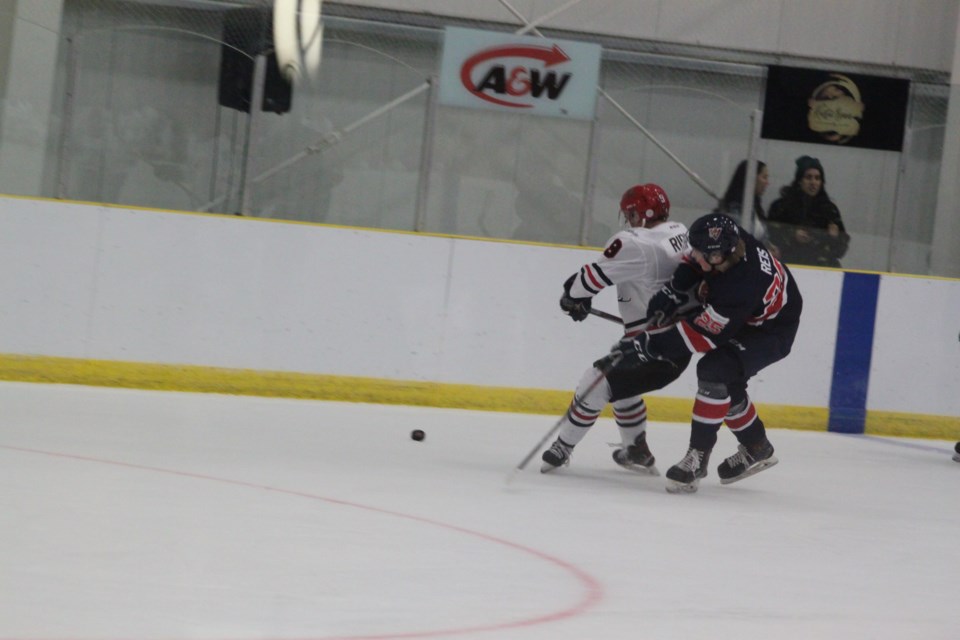Portage College Voyageurs forward Matteus Reis collides with Gerrik Ripley of the Augustana Vikings during the first period of the game. 
Chris McGarry photo. 

