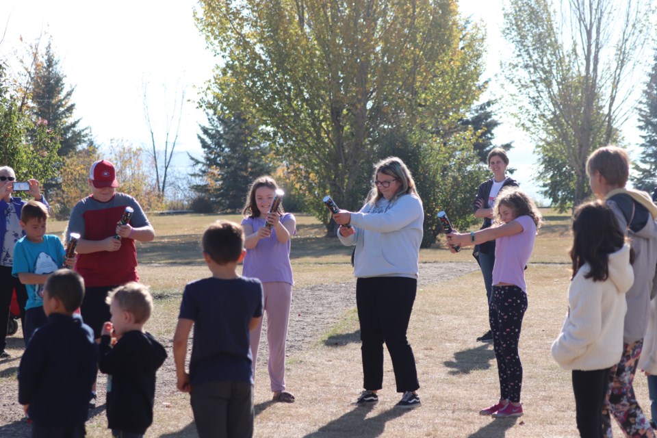 Youths popped confetti poppers to celebrate the grand opening of the new playground at the Lagasse Park on Oct. 7.