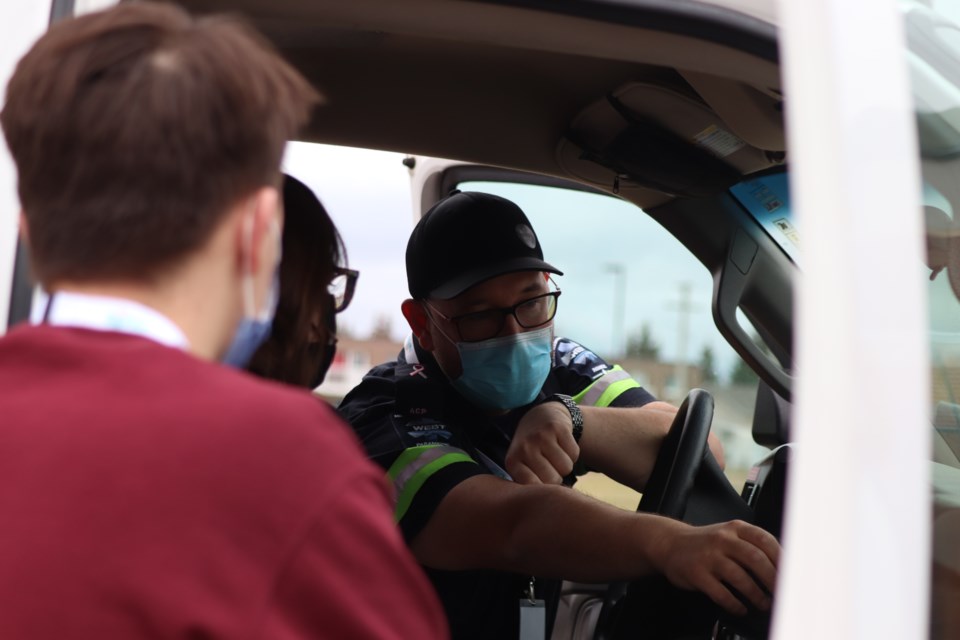 St. Paul paramedics show visiting Francophone nursing and healthcare aide students from the University of Alberta (U of A) how to respond to emergency situations which include transporting individuals in need of care, as part of an educational weekend tour in St. Paul and Elk Point last weekend Oct. 21-23.