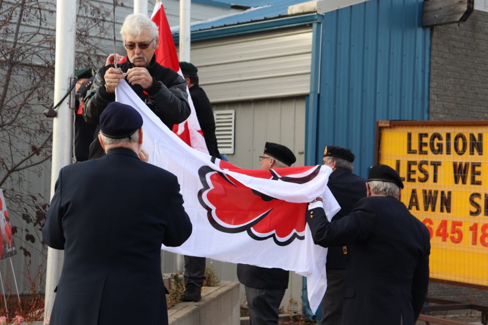 Guy Pomerleau with the St. Paul Royal Canadian Legion helps raise the flag to start the annual Poppy Campaign on Oct. 28.