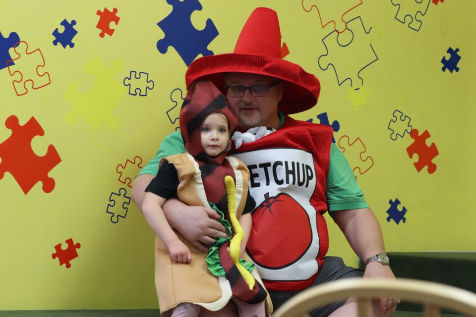 Jerred Moore dresses up with his daughter Alexis at the St. Paul Municipal Library's "Costume Party Story-time with Ms. Zimmerman" on Oct. 29.