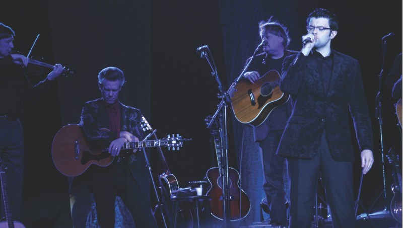 Gospel singer Eamonn McCrystal joins Randy Travis on stage for some inspirational music at the C2 Centre on May 4. On fiddle is David Johnson while Lance Dary plays guitar.