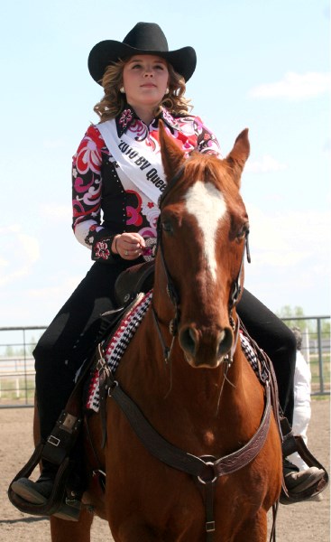 Queen contestant Carolynne Vallee rides her horse by the stands on Saturday.