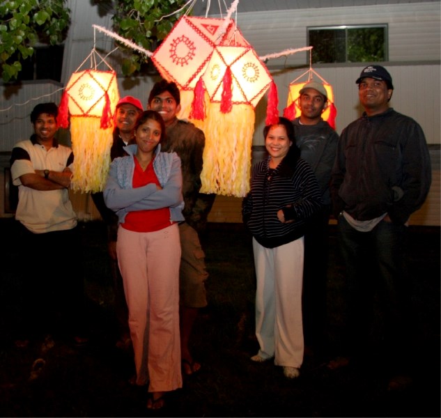 Vesak lantern creators stand with their beautiful creations.